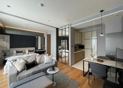 Modern studio apartment with integrated living, sleeping, and kitchen areas