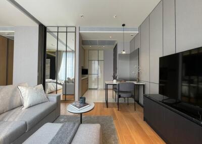 Modern living room with adjacent dining area and view into the bedroom