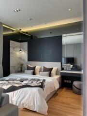 Modern bedroom with king-size bed, wall-mounted mirror, and reading lights