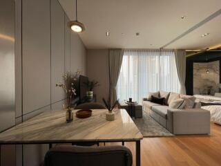 Modern living room with a dining area and a large window