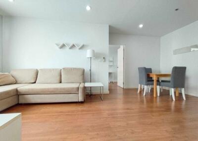 Modern living room with beige sofa and dining area