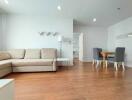 Modern living room with beige sofa and dining area