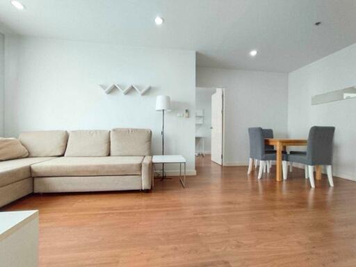 Modern living room with beige sofa and dining area