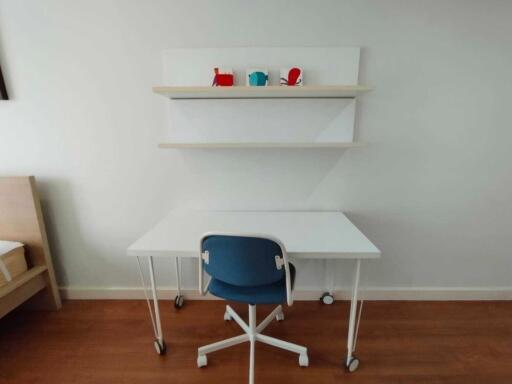 Minimalist bedroom with a study desk, chair, and shelves