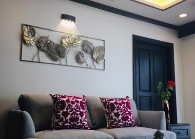 Modern living room with gray sofa and red pillows