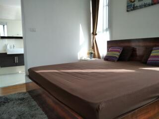 Bedroom with large bed and brown bedding