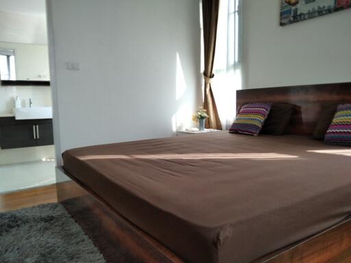 Bedroom with large bed and brown bedding