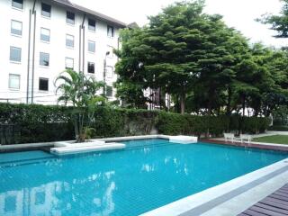 Apartment building with a swimming pool and garden