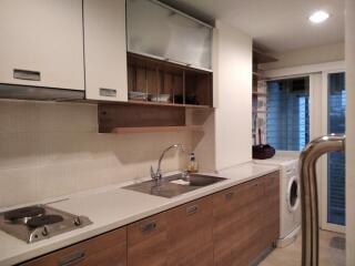 Modern kitchen with built-in appliances and wooden cabinets