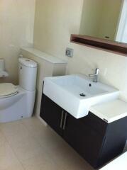 Modern bathroom with sink, toilet, and mirror