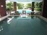 Outdoor swimming pool with seating area and greenery