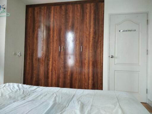 Bedroom with wooden wardrobe and white door