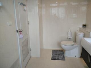 Modern bathroom with toilet, vanity, and door