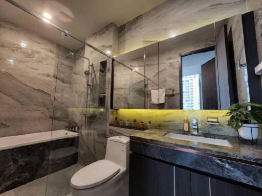 Modern bathroom with glass-enclosed shower and bathtub