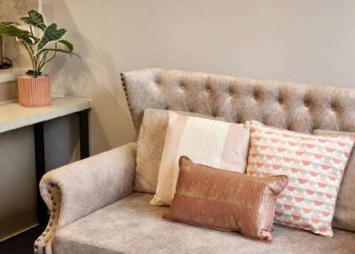 Living room with beige couch and decorative pillows