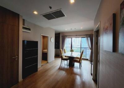 Modern dining area with wooden flooring and large windows