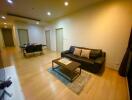 Modern living room with leather sofa and dining area