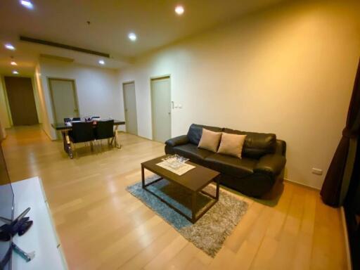 Modern living room with leather sofa and dining area