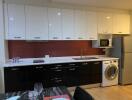 Modern kitchen with appliances and red backsplash