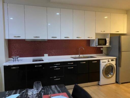 Modern kitchen with appliances and red backsplash