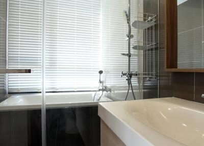 Modern bathroom with glass shower enclosure and bathtub