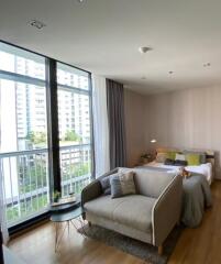 Modern bedroom with large windows and a seating area