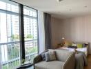 Modern bedroom with large windows and a seating area