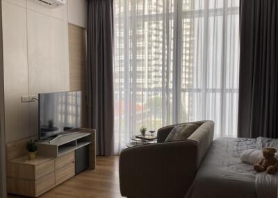 Modern living room with large windows and a couch