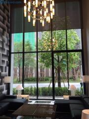 Modern living room with large glass windows and chandelier