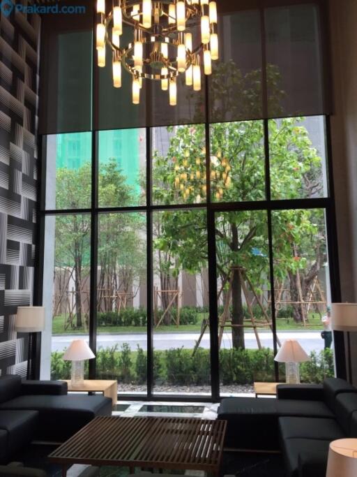 Modern living room with large glass windows and chandelier