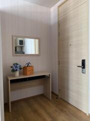 Modern entrance with a wooden door and a small table