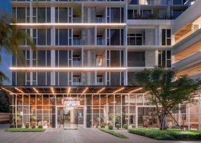 Modern multi-story apartment building with illuminated facade