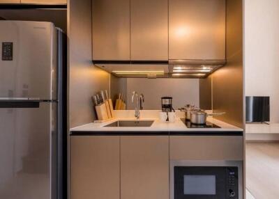 Modern kitchen with stainless steel appliances and lighting