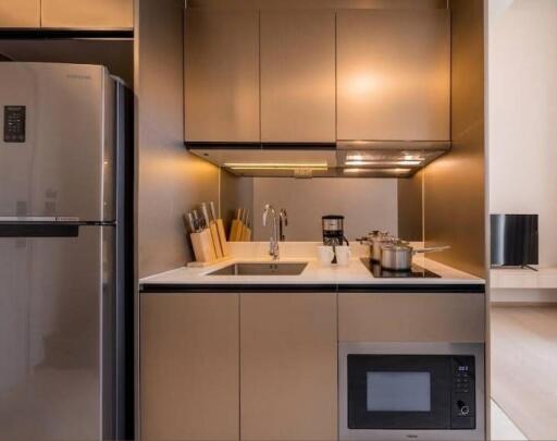 Modern kitchen with stainless steel appliances and lighting