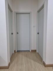 Hallway with three white doors