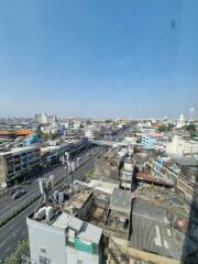 A panoramic view of a cityscape with numerous buildings and a clear blue sky