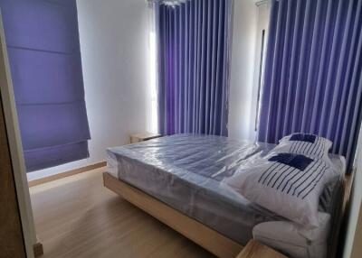 Modern bedroom with wooden furniture and purple curtains