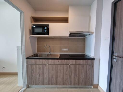 Modern kitchen with wooden cabinets and built-in appliances