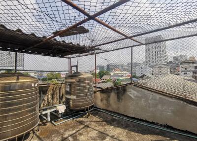 Rooftop with water tanks and city view