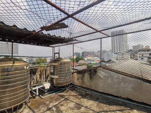 Rooftop with water tanks and city view