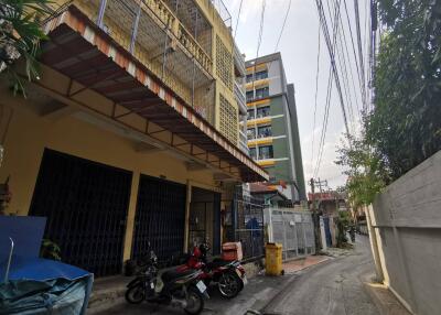 Apartment building exterior with motorcycles parked in front