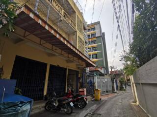 Apartment building exterior with motorcycles parked in front