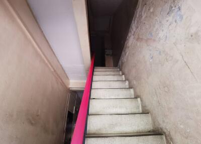 Interior staircase with white steps and red railing