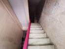 Interior staircase with white steps and red railing