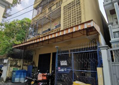 Exterior of multi-story building with gated entrance