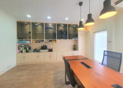 Modern office space with wooden table and storage cabinets