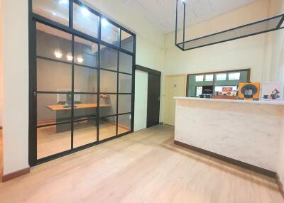 Modern office lobby with glass partition and front desk