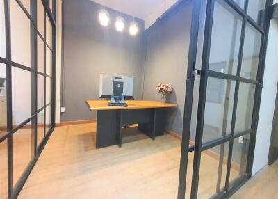 Modern office with glass walls and a wooden desk