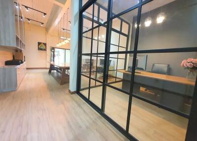 Modern office space with wooden flooring and glass partitions