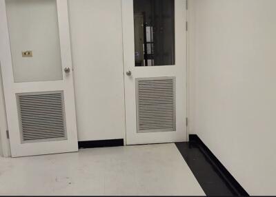 Clean white hallway with doors